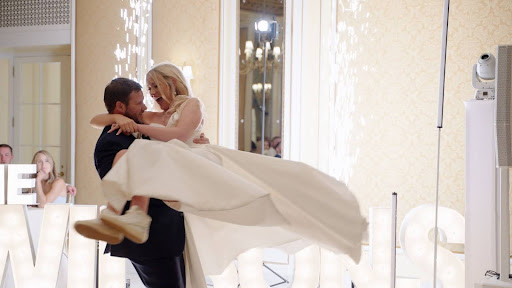 Groom lifts bride on the dance floor at The Broadmoor Denver reception