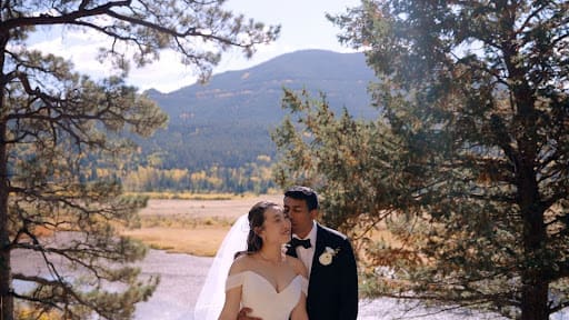Reia Cho and Rahul Madduluri embracing during mountain portraits in Rocky Mountain National Park near Estes Park, Colorado