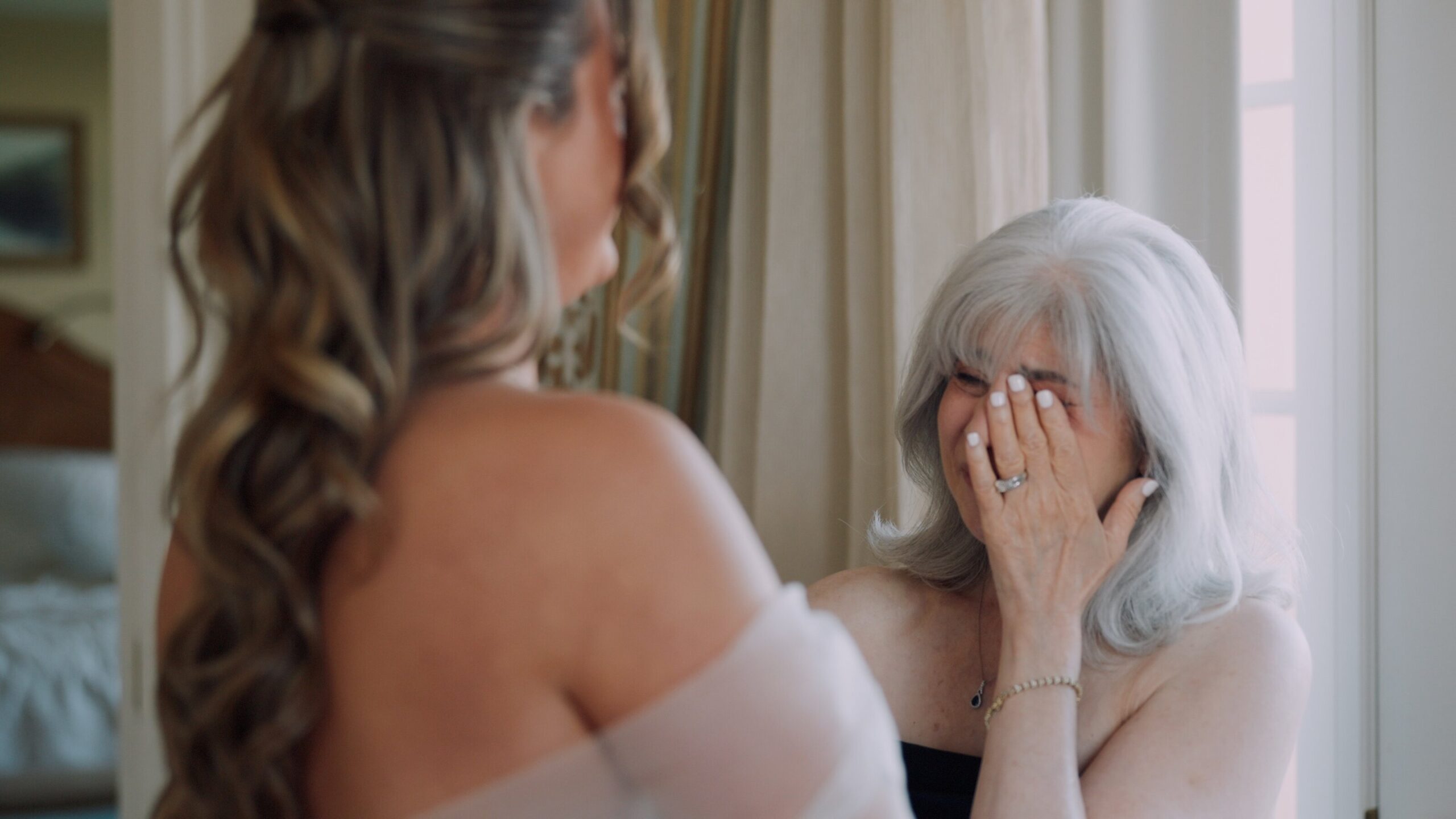 Emotional wedding moment of mother reacting during getting ready captured on video in Colorado