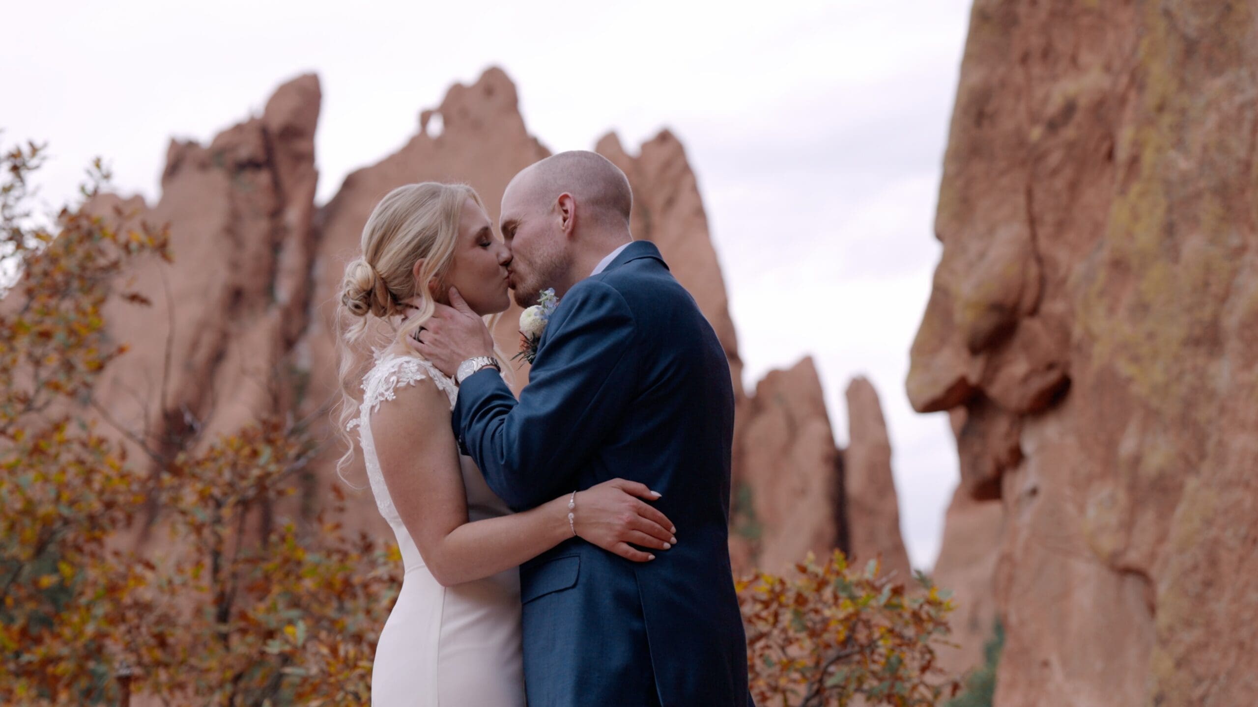 Bride and groom walking together during golden hour portraits with a Colorado wedding videographer filming candid moments